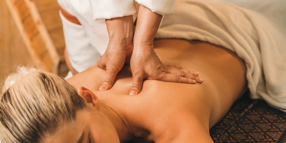 Woman receiving a massage at a massage studio.
