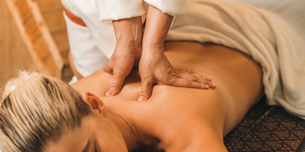 Woman receiving a massage at a massage studio.