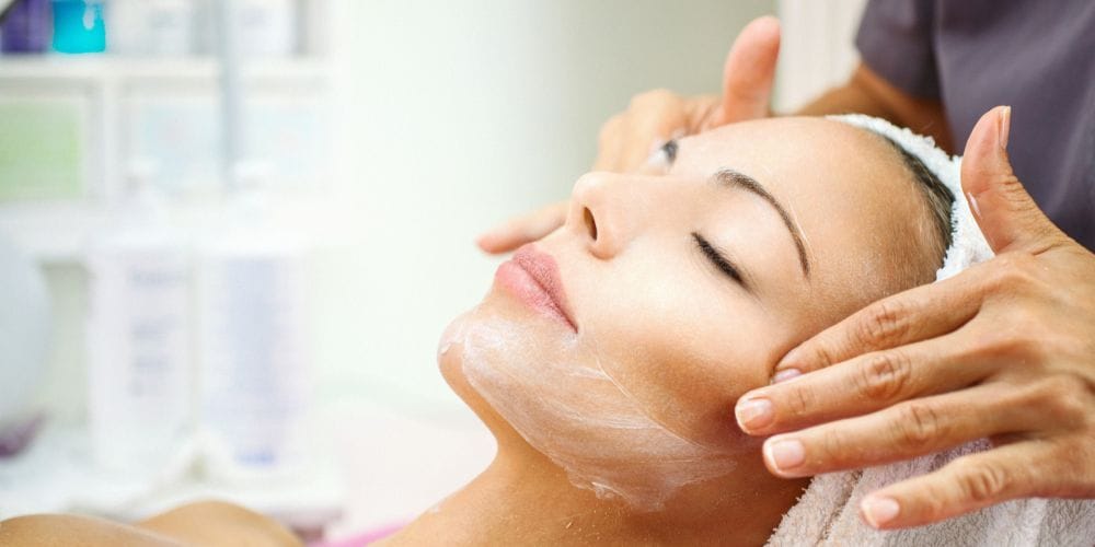 Woman receiving a facial at a local facial spa.